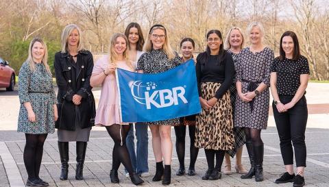 employees holding KBR flag