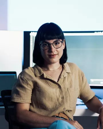 Young woman in glasses sitting at a desk