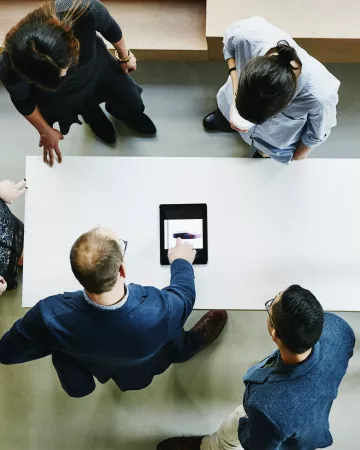 Birdseye view of coworkers gathered around a table