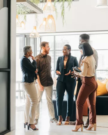 Coworkers gathered together in a lobby chatting