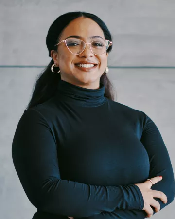 Young woman smiling with arms crossed